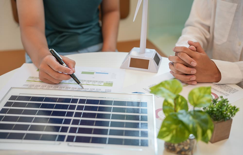 Mauritius family reviewing electricity bills beside solar panels